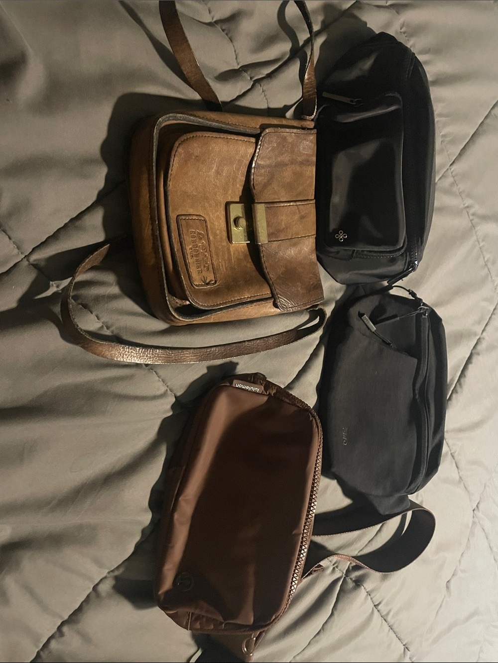 Brown Leather Crossbody bag, Lululemon brown hip bag, and 2 black hip bags .